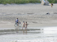 Riding bicycle down the beach with baby Cocoa Beach Florida