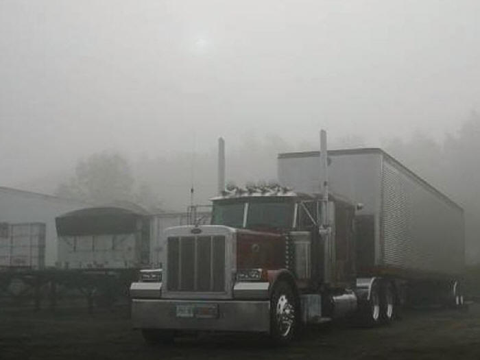 Great Dane trailer on Peterbilt tractor early morning in fog